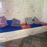 Stone bench with cushions and table tops