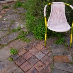 Crazy paving terrace and a garden chair